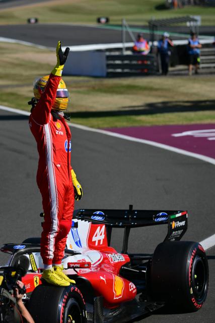 Ferrari's British driver Lewis Hamilton celebrates his pole position after the sprint qualifying session ahead of the Formula One British Grand Prix at the Silverstone motor racing circuit in Silverstone, central England, on July 3, 2026. (Photo by Andrej ISAKOVIC / AFP)