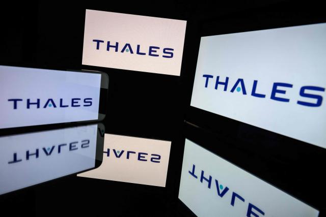 (FILES) This photograph shows screens displaying the logo of the company Thales, listed on the CAC 40, the main stock market index of the Paris Stock Exchange, in Toulouse on March 31, 2026. The French technology and defense group Thales announced on July 3, 2026, that it expects to book an exceptional charge of around 450 million euros in the first half of 2026, as a direct consequence of Germany’s decision to scrap its large F126 frigate program. (Photo by Lionel BONAVENTURE / AFP)