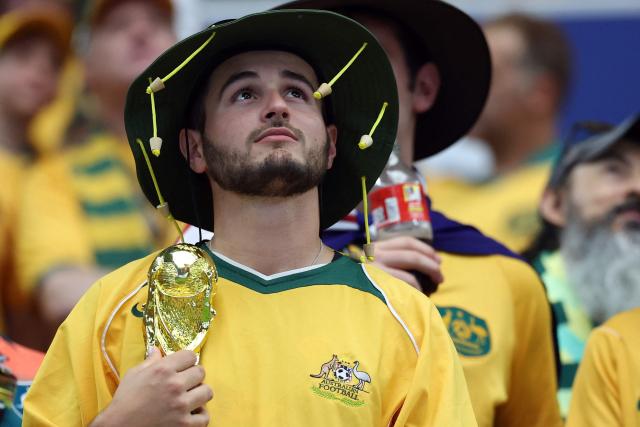 An Australia supporter holds a model of the competition trophy prior to the 2026 World Cup round of 32 football match between Australia and Egypt at the Dallas Stadium in Arlington on July 3, 2026.  (Photo by Thomas COEX / AFP)