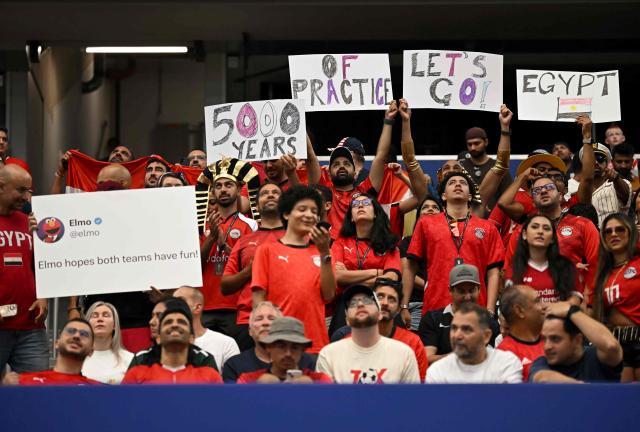 Egypt supporters holds placards in the tribunes prior to the 2026 World Cup round of 32 football match between Australia and Egypt at the Dallas Stadium in Arlington on July 3, 2026.  (Photo by Paul ELLIS / AFP)