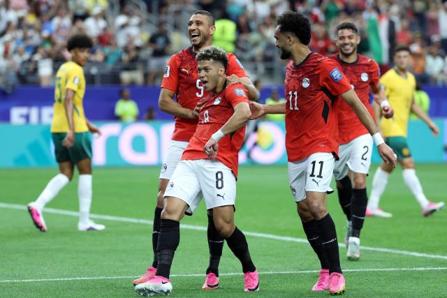TOPSHOT - Egypt's midfielder #08 Emam Ashour (C) celebrates with teammates after scoring the opening goal during the 2026 World Cup round of 32 football match between Australia and Egypt at the Dallas Stadium in Arlington on July 3, 2026.  (Photo by Thomas COEX / AFP)