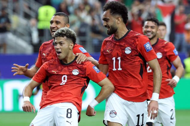 Egypt's midfielder #08 Emam Ashour (C) celebrates with Egypt's defender #05 Ramy Rabia (L) and Egypt's midfielder #11 Mostafa Ziko (R) after scoring the opening goal during the 2026 World Cup round of 32 football match between Australia and Egypt at the Dallas Stadium in Arlington on July 3, 2026.  (Photo by Thomas COEX / AFP)