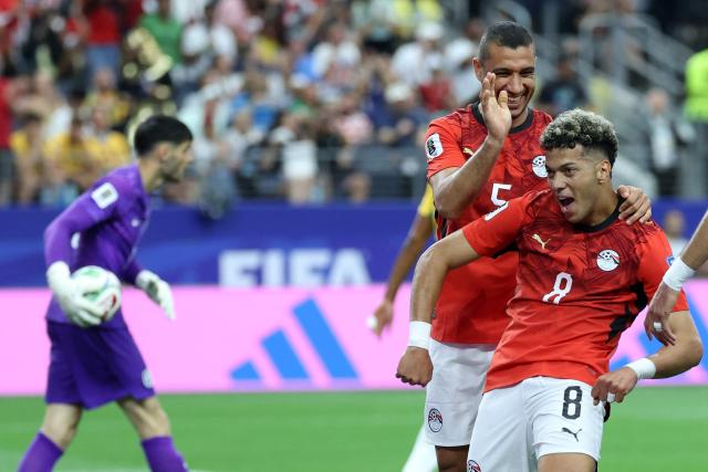 Egypt's midfielder #08 Emam Ashour (R) celebrates with Egypt's defender #05 Ramy Rabia after scoring the opening goal during the 2026 World Cup round of 32 football match between Australia and Egypt at the Dallas Stadium in Arlington on July 3, 2026.  (Photo by Thomas COEX / AFP)