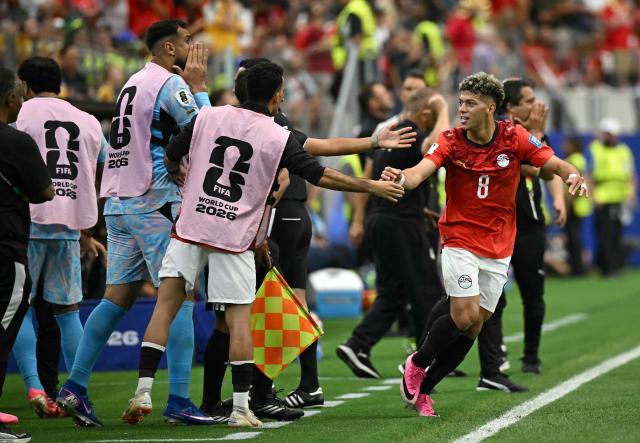 Egypt's midfielder #08 Emam Ashour celebrates with teammates after scoring the opening goal during the 2026 World Cup round of 32 football match between Australia and Egypt at the Dallas Stadium in Arlington on July 3, 2026.  (Photo by Paul ELLIS / AFP)