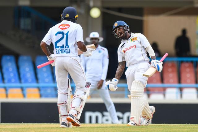 Lahiru Udara (R) of Sri Lanka celebrates his century during the 1st day of the 2nd Test between Sri Lanka and West Indies at Vivian Richards Cricket Stadium in North Sound, Antigua and Barbuda, on July 3, 2026. (Photo by Randy Brooks / AFP)