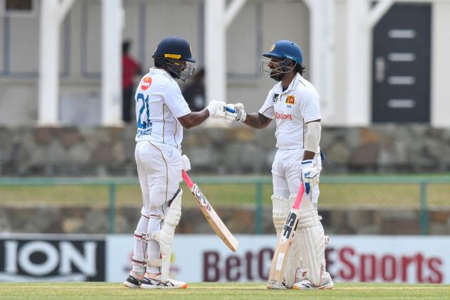 Kamindu Mendis (L) and Lahiru Udara (R) of Sri Lanka celebrate their 150 runs partnership during the 1st day of the 2nd Test between Sri Lanka and West Indies at Vivian Richards Cricket Stadium in North Sound, Antigua and Barbuda, on July 3, 2026. (Photo by Randy Brooks / AFP)
