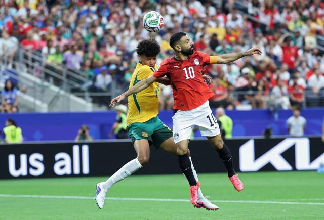Australia's defender #25 Lucas Herrington (L) and Egypt's forward #10 Mohamed Salah jump for the ball  during the 2026 World Cup round of 32 football match between Australia and Egypt at the Dallas Stadium in Arlington on July 3, 2026.  (Photo by Thomas COEX / AFP)