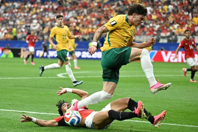 Australia's defender #05 Jordan Bos (up) is tackled by Egypt's midfielder #19 Marwan Attia  during the 2026 World Cup round of 32 football match between Australia and Egypt at the Dallas Stadium in Arlington on July 3, 2026.  (Photo by Paul ELLIS / AFP)