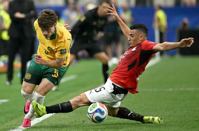 Australia's defender #05 Jordan Bos (L) is tackled by Egypt's midfielder #25 Zizo  during the 2026 World Cup round of 32 football match between Australia and Egypt at the Dallas Stadium in Arlington on July 3, 2026.  (Photo by Paul ELLIS / AFP)