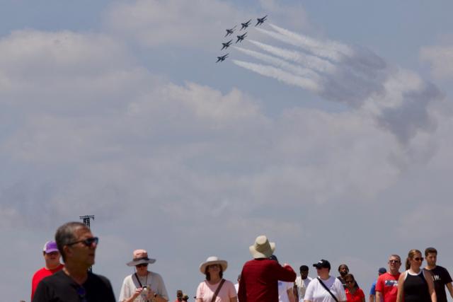People gather on the National Mall as a US Air Force Thunderbirds demonstration squadron flies overhead in Washington, DC, on July 3, 2026, ahead of the upcoming July 4 holiday. (Photo by Amid FARAHI / AFP)