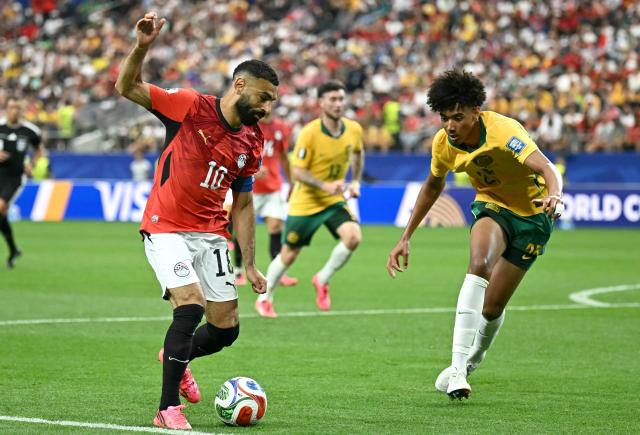 Egypt's forward #10 Mohamed Salah (L) fights for the ball with Australia's defender #25 Lucas Herrington  during the 2026 World Cup round of 32 football match between Australia and Egypt at the Dallas Stadium in Arlington on July 3, 2026.  (Photo by Paul ELLIS / AFP)