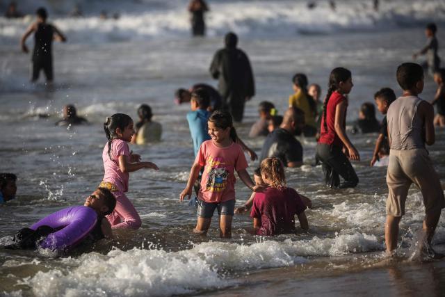 Palestinian children swim in the ocean in Gaza City on July 3, 2026. The Gaza war was triggered by Hamas's October 7, 2023 attack on Israel, prompting Israel to launch a retaliatory campaign against the territory. A ceasefire took hold in October but progress on permanently ending the war has stalled, and Israeli forces currently control nearly 70 percent of the territory. (Photo by EYAD BABA / AFP)