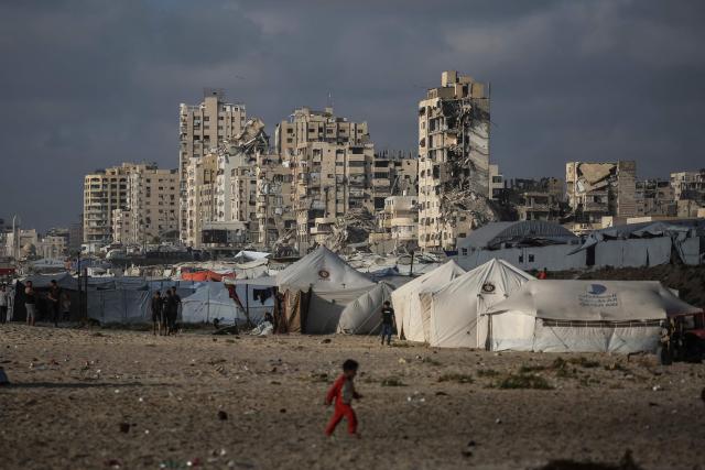 A Palestinian child walks near a camp for the displaced on the beach in Gaza City on July 3, 2026. The Gaza war was triggered by Hamas's October 7, 2023 attack on Israel, prompting Israel to launch a retaliatory campaign against the territory. A ceasefire took hold in October but progress on permanently ending the war has stalled, and Israeli forces currently control nearly 70 percent of the territory. (Photo by EYAD BABA / AFP)