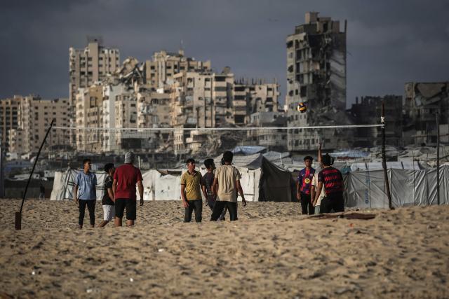 Palestinians play volley ball along on the beach front in Gaza City on July 3, 2026. The Gaza war was triggered by Hamas's October 7, 2023 attack on Israel, prompting Israel to launch a retaliatory campaign against the territory. A ceasefire took hold in October but progress on permanently ending the war has stalled, and Israeli forces currently control nearly 70 percent of the territory. (Photo by EYAD BABA / AFP)