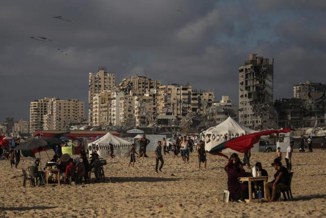 Palestinians gather along on the beach front in Gaza City on July 3, 2026. The Gaza war was triggered by Hamas's October 7, 2023 attack on Israel, prompting Israel to launch a retaliatory campaign against the territory. A ceasefire took hold in October but progress on permanently ending the war has stalled, and Israeli forces currently control nearly 70 percent of the territory. (Photo by EYAD BABA / AFP)