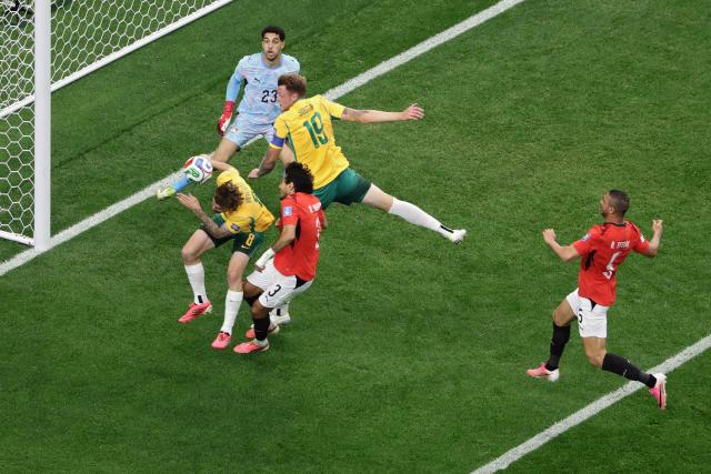 Egypt's defender #03 Mohamed Hany (C) fights for the ball with Australia's midfielder #08 Connor Metcalfe (L) and Australia's defender #19 Harry Souttar (R)  during the 2026 World Cup round of 32 football match between Australia and Egypt at the Dallas Stadium in Arlington on July 3, 2026.  (Photo by Aric Becker / AFP)