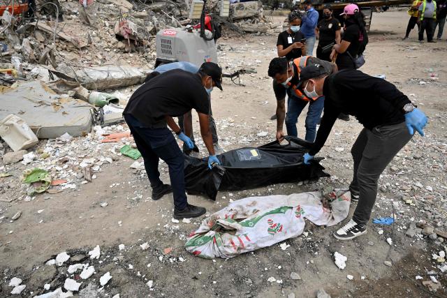Two bodies recovered from the rubble of collapsed buildings lie on the ground during recovery operations in Caraballeda, La Guaira, Venezuela, on July 3, 2026. The death toll from Venezuela's twin earthquakes has risen to 2,595, Interim President Delcy Rodriguez said on July 2. (Photo by MARTIN BERNETTI / AFP)