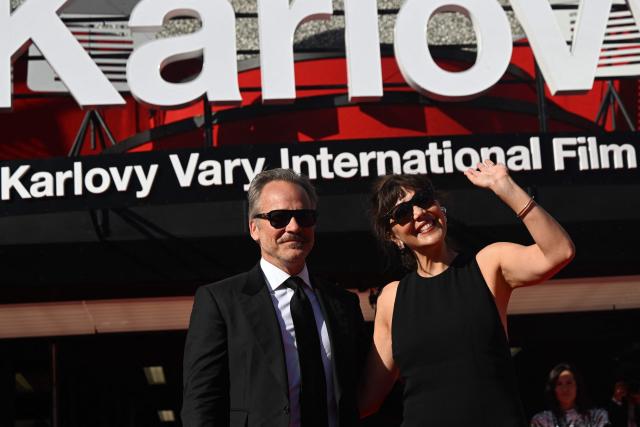US actress Maggie Gyllenhaal and her husband US actor Peter Sarsgaard poses on the red carpet during the opening of the 60th Karlovy Vary International Film Festival (KVIFF) in Karlovy Vary, Czech Republic on July 3, 2026. (Photo by Michal Cizek / AFP)