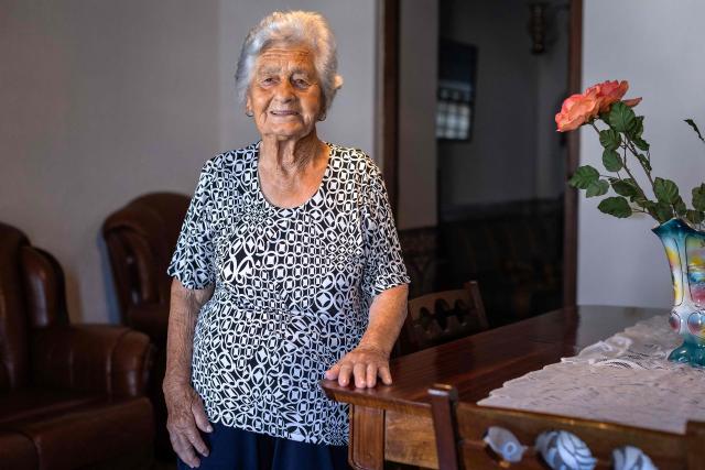 Maria Rosel, 94 years old, resident of the village of Vale de Figueira, Santarem, Portugal, stands inside her house due to high temperatures hitting the area, on July 3, 2026. Parts of Portugal are under red alert due to forecast high temperatures in the coming days after being relatively spared by the recent European heatwave, with the IPMA weather agency placing regions including Leiria and Coimbra on alert through Friday as temperatures could reach 44°C in some areas. (Photo by HENRIQUE CASINHAS / AFP)