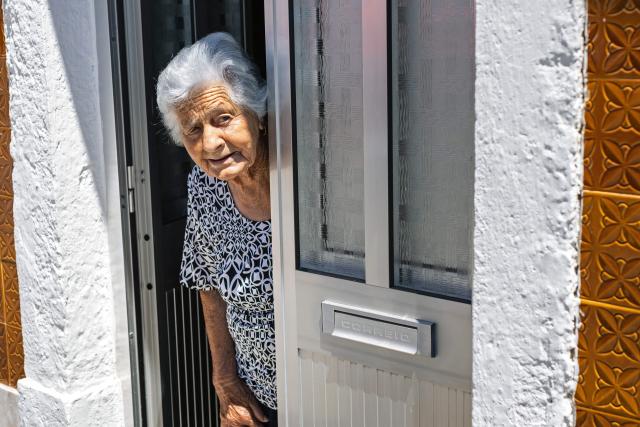 Maria Rosel, 94 years old, resident of the village of Vale de Figueira, Santarem, Portugal, takes refuge inside her house due to high temperatures hitting the area, on July 3, 2026. Parts of Portugal are under red alert due to forecast high temperatures in the coming days after being relatively spared by the recent European heatwave, with the IPMA weather agency placing regions including Leiria and Coimbra on alert through Friday as temperatures could reach 44°C in some areas. (Photo by HENRIQUE CASINHAS / AFP)