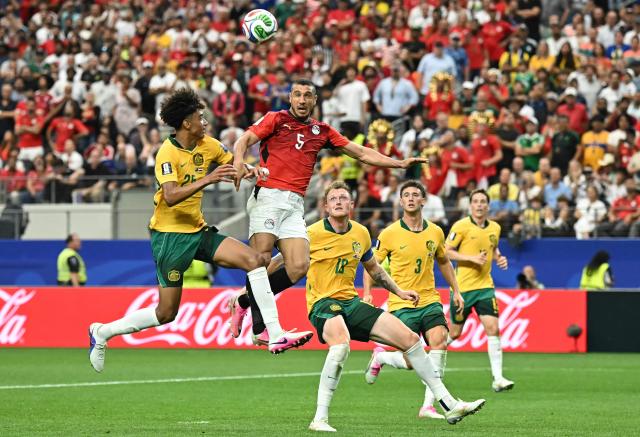 Egypt's defender #05 Ramy Rabia (C) and Australia's defender #25 Lucas Herrington (L) jump for the ball  during the 2026 World Cup round of 32 football match between Australia and Egypt at the Dallas Stadium in Arlington on July 3, 2026.  (Photo by Paul ELLIS / AFP)