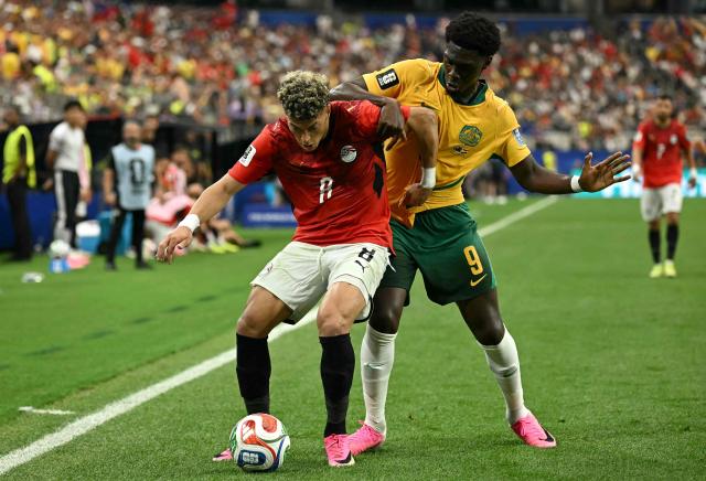 Egypt's midfielder #08 Emam Ashour (L) fights for the ball with Australia's forward #09 Mohamed Toure during the 2026 World Cup round of 32 football match between Australia and Egypt at the Dallas Stadium in Arlington on July 3, 2026.  (Photo by Paul ELLIS / AFP)