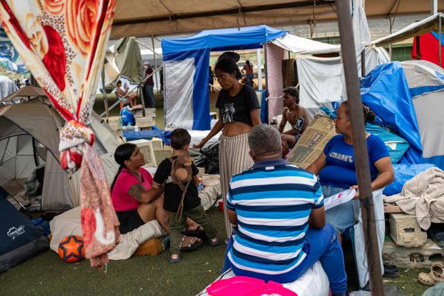 Displaced people take shelter in tents at the Cesar Nieves baseball stadium in the La Angustia neighborhood of Catia La Mar, La Guaira state, Venezuela, on July 3, 2026. The death toll from Venezuela's devastating twin earthquakes has risen to 2,645, with more than 12,600 injured, according to new official figures released on July 3. (Photo by Miguel MEDINA / AFP)