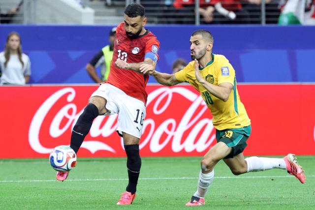 Egypt's forward #10 Mohamed Salah (L)  fights for the ball with Australia's defender #16 Aziz Behich during the 2026 World Cup round of 32 football match between Australia and Egypt at the Dallas Stadium in Arlington on July 3, 2026.  (Photo by Thomas COEX / AFP)
