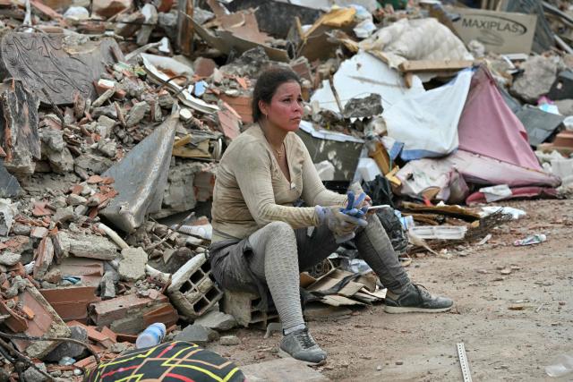 A volunteer rests on rubble at the site of a collapsed building in Caraballeda, La Guaira state, Venezuela, on July 3, 2026. The death toll from Venezuela's devastating twin earthquakes has risen to 2,645, with more than 12,600 injured, according to new official figures released on July 3. (Photo by MARTIN BERNETTI / AFP)