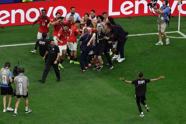 Egypt's players celebrate after winning the 2026 World Cup round of 32 football match between Australia and Egypt at the Dallas Stadium in Arlington on July 3, 2026.  (Photo by Aric Becker / AFP)