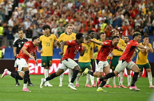 Egypt's players celebrate after winning the 2026 World Cup round of 32 football match between Australia and Egypt at the Dallas Stadium in Arlington on July 3, 2026.  (Photo by Paul ELLIS / AFP)