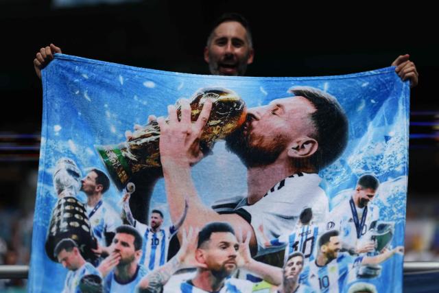 An Argentine fan displays a towel depicting Argentine football player Lionel Messi ahead of the 2026 World Cup round of 32 football match between Argentina and Cape Verde at the Miami Stadium in Miami Gardens on July 3, 2026.  (Photo by PATRICIA DE MELO MOREIRA / AFP)