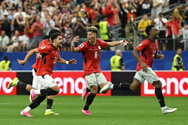 Egypt's players celebrate after winning the 2026 World Cup round of 32 football match between Australia and Egypt at the Dallas Stadium in Arlington on July 3, 2026.  (Photo by Paul ELLIS / AFP)