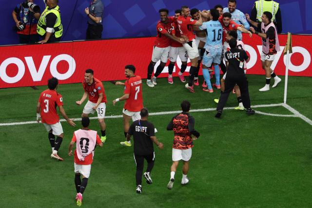 Egypt's players celebrate after winning the 2026 World Cup round of 32 football match between Australia and Egypt at the Dallas Stadium in Arlington on July 3, 2026.  (Photo by Aric Becker / AFP)