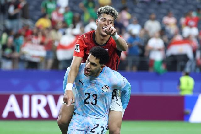 Egypt's goalkeeper #23 Mostafa Shoubir (L) and Egypt's midfielder #08 Emam Ashour celebrate after winning the 2026 World Cup round of 32 football match between Australia and Egypt at the Dallas Stadium in Arlington on July 3, 2026.  (Photo by Thomas COEX / AFP)