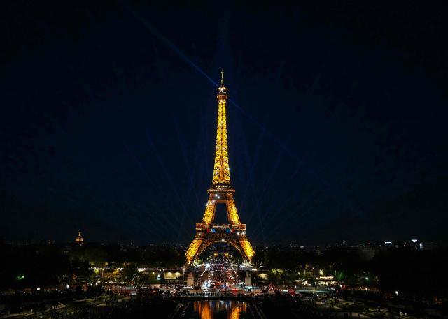 This photograph shows a view of the Eiffel tower during a light show a day prior to the 250th anniversary of the US' Declaration of Independence in Paris on July 3, 2026.  (Photo by Dimitar DILKOFF / AFP)