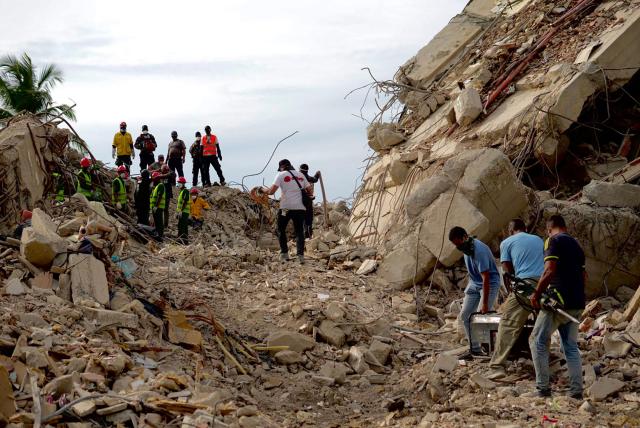 Rescuers search for vitims of the June 24 twin quakes at the site of a collapsed building in Tanaguarena sector in Caraballeda, La Guaira State, Venezuela on July 3, 2026. The death toll from Venezuela's devastating twin earthquakes has risen to 2,645, with more than 12,600 injured and thousands mores reported still missing, according to new official figures. (Photo by MARTIN BERNETTI / AFP)
