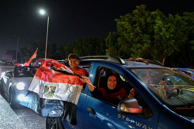 A young Egyptian fan waves the flag of Egypt as they celebrate the team's victory in the 2026 World Cup Round of 32 football match against Australia in Al-Shorouk City, east of Cairo, on July 4, 2026. (Photo by Khaled DESOUKI / AFP)