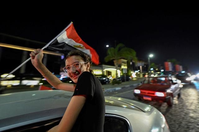 An Egyptian fan waves the flag of Egypt as they celebrate the team's victory in the 2026 World Cup Round of 32 football match against Australia in Al-Shorouk City, east of Cairo, on July 4, 2026. (Photo by Khaled DESOUKI / AFP)