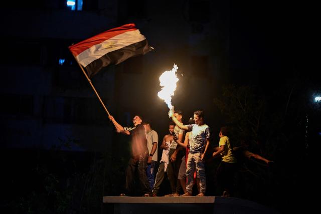Egyptian fans celebrate their team's victory in the 2026 World Cup Round of 32 football match against Australia in Al-Shorouk City, east of Cairo, on July 4, 2026. (Photo by Khaled DESOUKI / AFP)