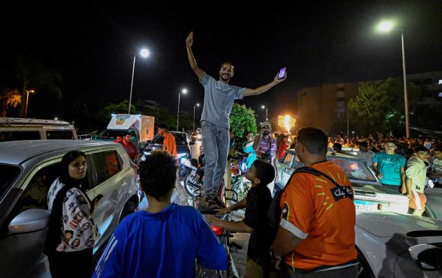 Egyptian fans celebrate their team's victory in the 2026 World Cup Round of 32 football match against Australia in Al-Shorouk City, east of Cairo, on July 4, 2026. (Photo by Khaled DESOUKI / AFP)