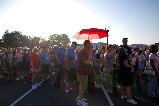 People wait in line for a concert at the US Capitol while dealing with extreme heat along the National Mall in Washington, DC, on July 3, 2026. Blistering temperatures and humidity has gripped swaths of the United States this week, with more to come for the densely populated East Coast as the nation co-hosts the World Cup and prepares to celebrate its 250th birthday on July 4. The heat wave that has been broiling the Midwest is intensifying in the Northeast, with temperatures surpassing 100F (38C) in cities including New York, Philadelphia and Washington. (Photo by Amid FARAHI / AFP)