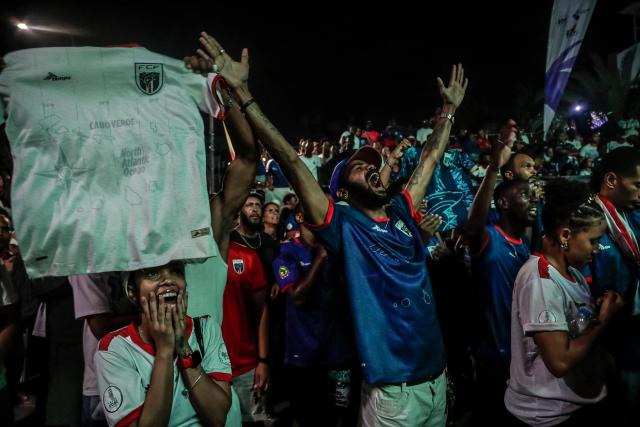TOPSHOT - Supporters of Cape Verde’s national football team celebrate Cape Verde’s second goal during the 2026 World Cup round of 32 football match between Argentina and Cape Verde in Praia on July 3, 2026. (Photo by Jose Correia / AFP)