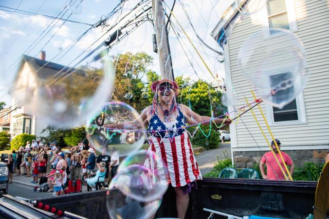 A woman creates bubbles during the Gloucester Fishtown Horribles Parade in Gloucester, Massachusetts on July 3, 2026. The parade is part of the city’s July 4th celebrations. (Photo by Joseph PREZIOSO / AFP)