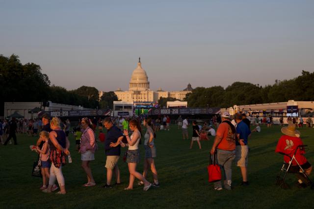 People gather at the Great American State Fair on the National Mall during celebrations marking the 250th anniversary of American independence in Washington, DC, on July 3, 2026, ahead of the upcoming July 4 holiday. The United States will mark the 250th anniversary of the nation's Declaration of Indpendence on July 4, 2026. (Photo by Amid FARAHI / AFP)