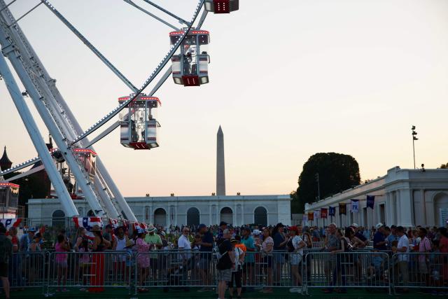 People gather at the Great American State Fair on the National Mall during a heat wave in Washington, DC, on July 3, 2026. Blistering temperatures and humidity has gripped swaths of the United States this week, with more to come for the densely populated East Coast as the nation co-hosts the World Cup and prepares to celebrate its 250th birthday on July 4. The heat wave that has been broiling the Midwest is intensifying in the Northeast, with temperatures surpassing 100F (38C) in cities including New York, Philadelphia and Washington. (Photo by Amid FARAHI / AFP)