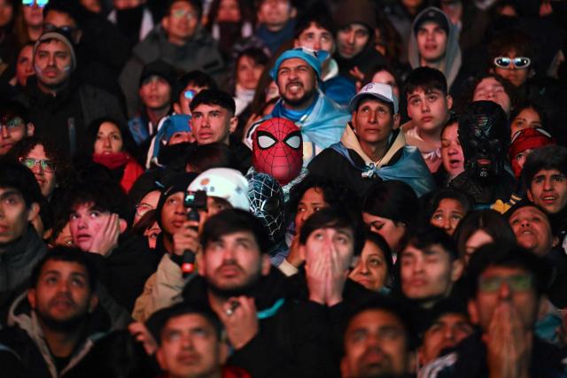 An Argentina supporter wearing a Spider-Man mask watches the 2026 FIFA World Cup Round of 32 football match between Argentina and Cape Verde on a giant screen in Buenos Aires on July 3, 2026. (Photo by Luis ROBAYO / AFP)