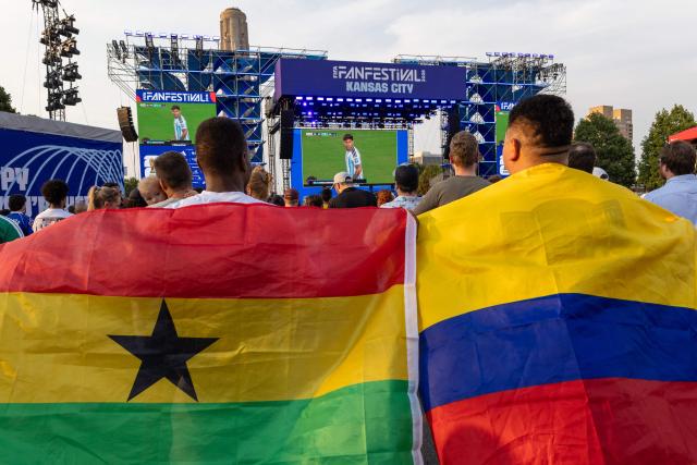 Football fans holding flags from Ghana and Colombia watch the final moments of Argentine and Cabo Verde's match at the FIFA Fan Festival as they wait for the WC 2026 Round of 32 match between Colombia and Ghana in Kansas City, Missouri on July 3, 2026. (Photo by Austin Johnson / AFP)
