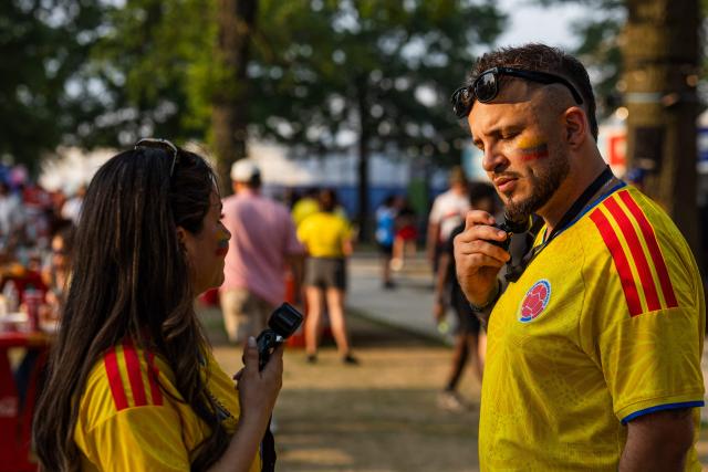 Colombia fans use small electric fans to cool off at the FIFA Fan Festival as they wait for the WC 2026 Round of 32 match between Colombia and Ghana in Kansas City, Missouri on July 3, 2026. (Photo by Austin Johnson / AFP)