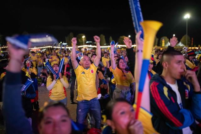 Colombia football fans cheer while watching the 2026 FIFA World Cup round of 32 match between Colombia and Ghana on a giant screen in Bogota on July 3, 2026. (Photo by ESTEBAN VEGA LA-ROTTA / AFP)